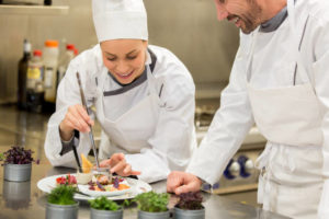 chef demonstrating putting the finishing touches on a plate