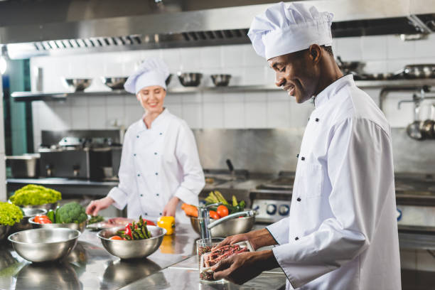 chef holding tray in restaurant kitchen