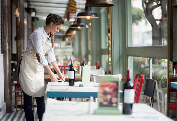 Waitress setting tables at a restaurant