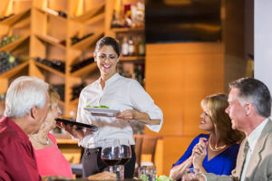 Waitress in restaurant serving food