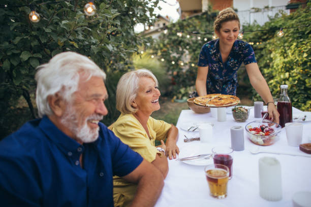 Photo of a senior couple having dinner at the garden