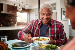 Senior Couple Enjoying Meal Around Table